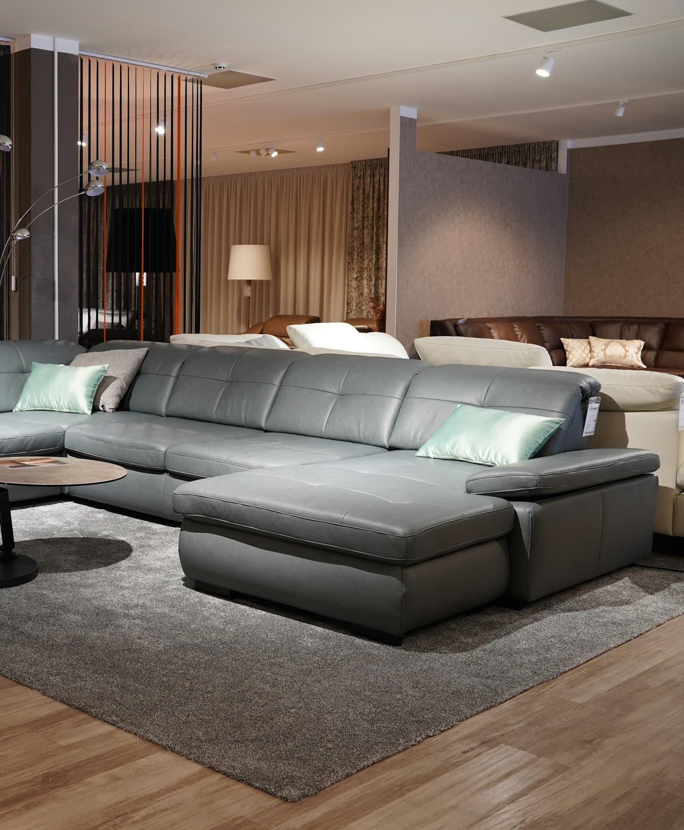 A furniture showroom with an upholstered sectional sofa